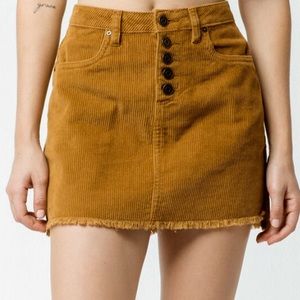 Indigo Rein Women’s 5/26 Half Button Front Corduroy Raw Hem Mini Skirt in Cognac